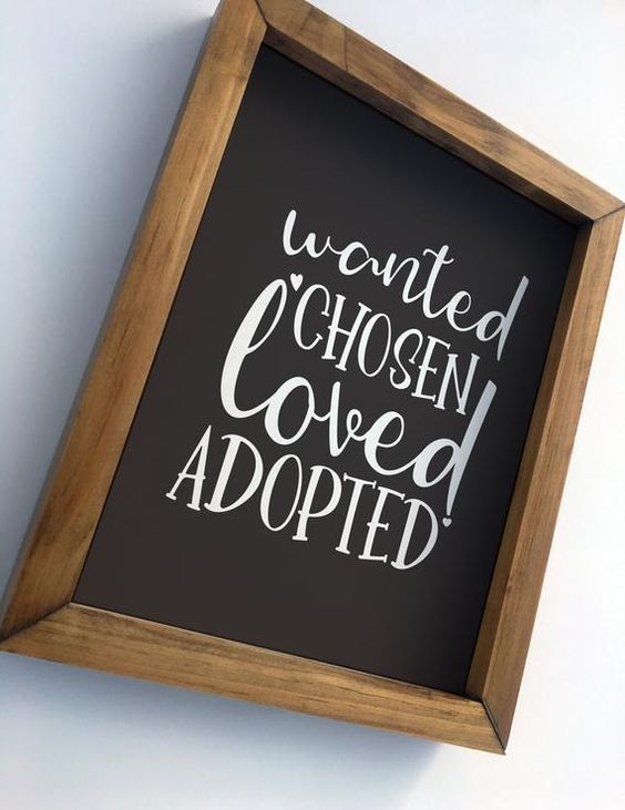 frame that has the text "Wanted Chosen Loved Adopted" written in white