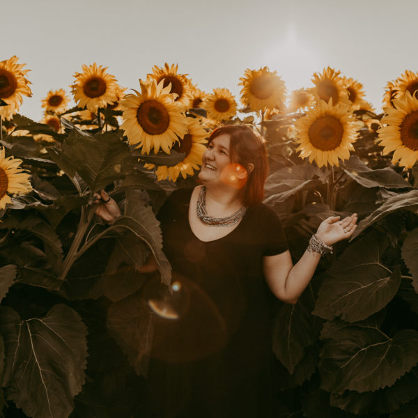 I'm standing in front of a wall of sunflowers
