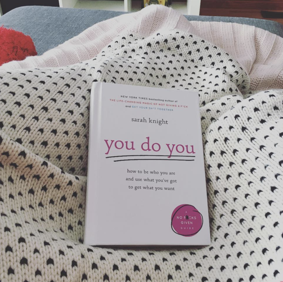 Sarah Knight's Book "You Do You" resting on a polka dot blanket