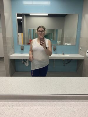A selfie of Matisse in a mirror in the gym bathroom.